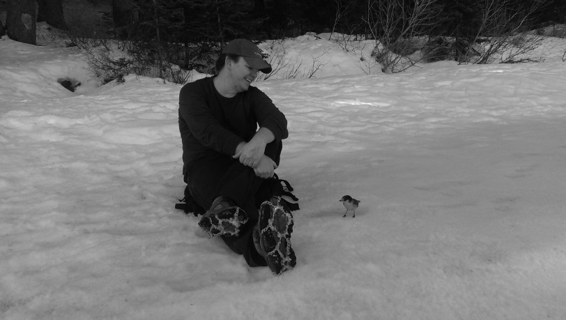 Two friends chatting lakeside.